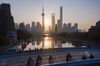 This aerial picture shows the sun rising behind the skyline of Shanghai's Lujiazui Financial District of Pudong on November 13, 2018. (Photo by Johannes EISELE / AFP) (Photo credit should read JOHANNES EISELE/AFP/Getty Images)