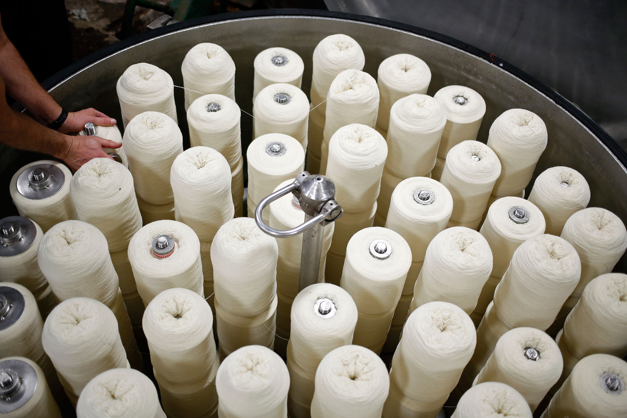 An employee secures packages of raw wool in a tank used to dye wool at the Woolrich Inc. woolen mill in Woolrich, Pennsylvania, U.S., on Wednesday, Nov. 4, 2015. Woolrich, the legendary Pennsylvania-based fabric maker, has been the source of classic, outdoorsy offerings—such as buffalo check shirts and warm, durable blankets—since 1830. Today, the iconic heritage brand sill churns out its heirloom-quality wool blankets by hand at the U.S.'s oldest continuously operating woolen mill.

