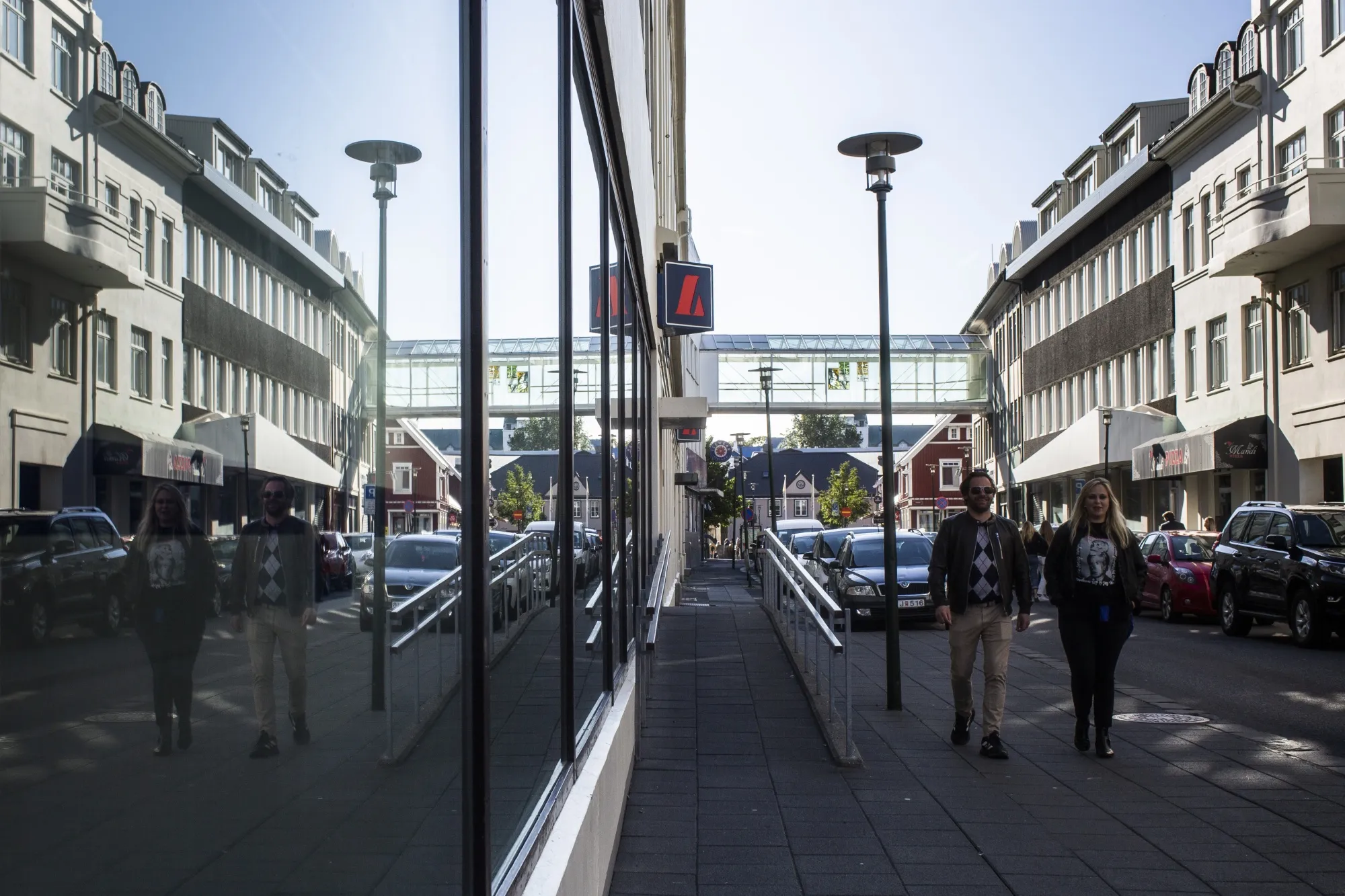 Pedestrians walk along a street in the city center of Reykjavik, Iceland.