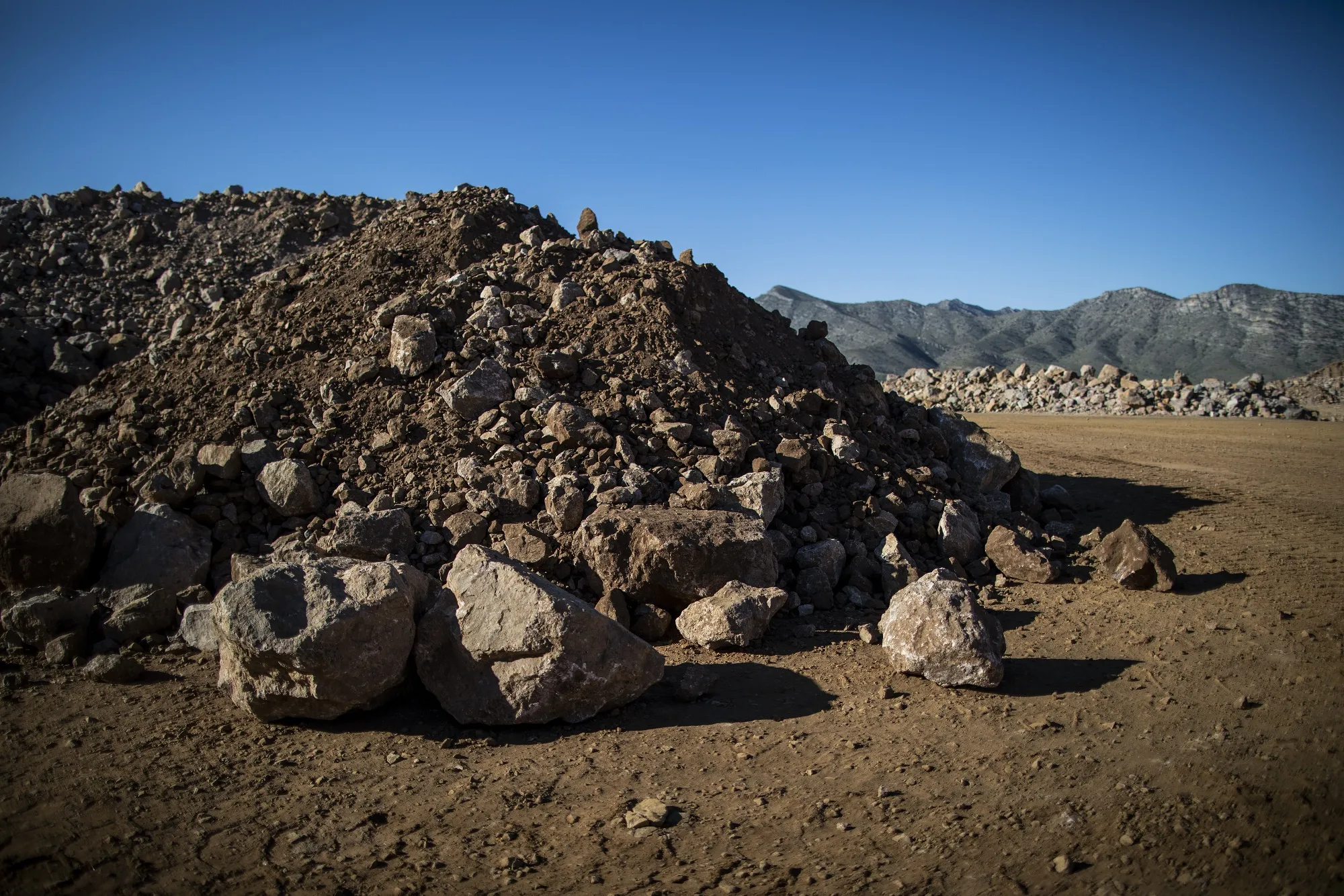 Piles of raw ore sit at a MP Materials mine&nbsp;in Mountain Pass, California.