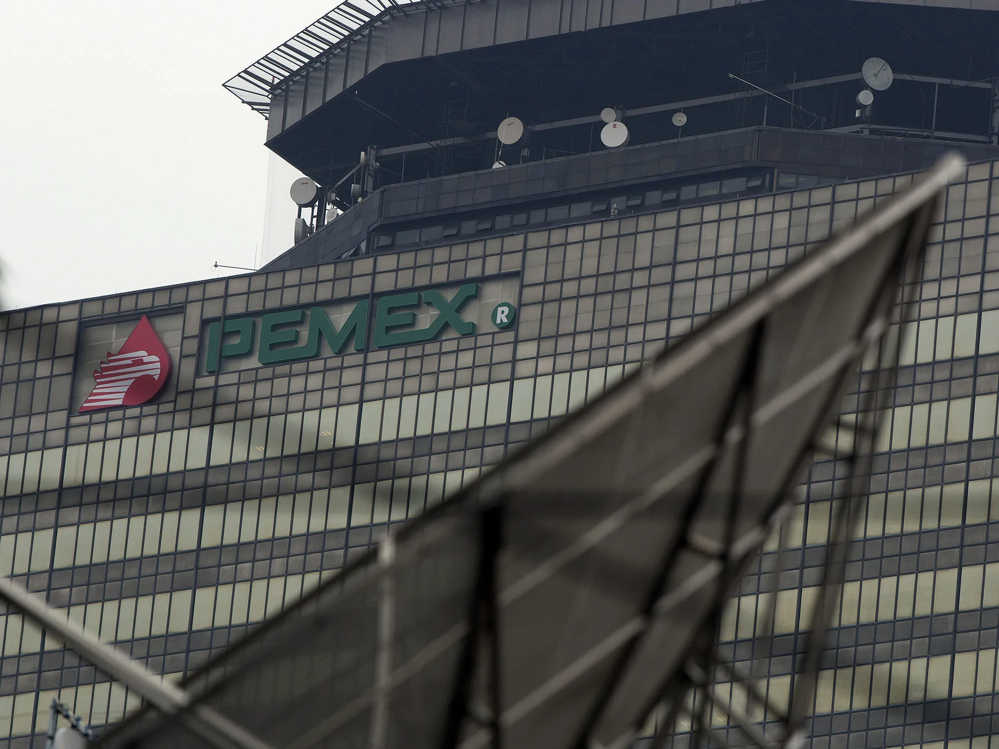 Signage for state-run oil company Petroleos Mexicanos, known as Pemex, is displayed on the company's headquarters building in Mexico City.