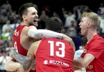 Poland's Mateusz Ponitka, left, and his teammates celebrate after the Eurobasket quarter final basketball match between Slovenia and Poland in Berlin, Germany, Wednesday, Sept. 14, 2022. Poland defeated Slovenia by 90-87. (AP Photo/Michael Sohn)