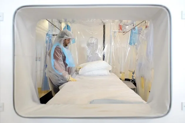 A nurse demonstrates the facilities at the Royal Free Hospital in London in preparation for a patient testing positive for the Ebola virus, on Aug. 6