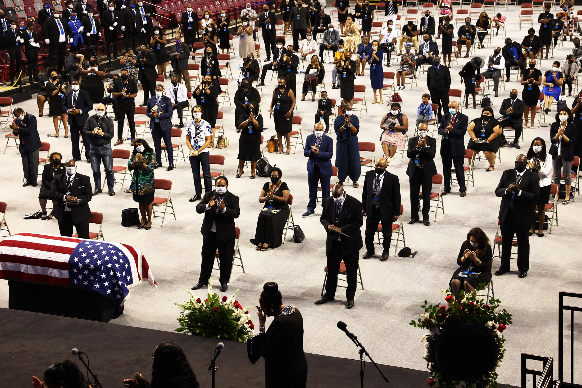 People stand and clap after Gospel recording artist Dottie Peoples sang "On Time God" during the​ “​The Boy from Troy”​ service celebrating the life of&nbsp;Representative&nbsp;John Lewis&nbsp; in Troy Alabama, o​n July 25.
