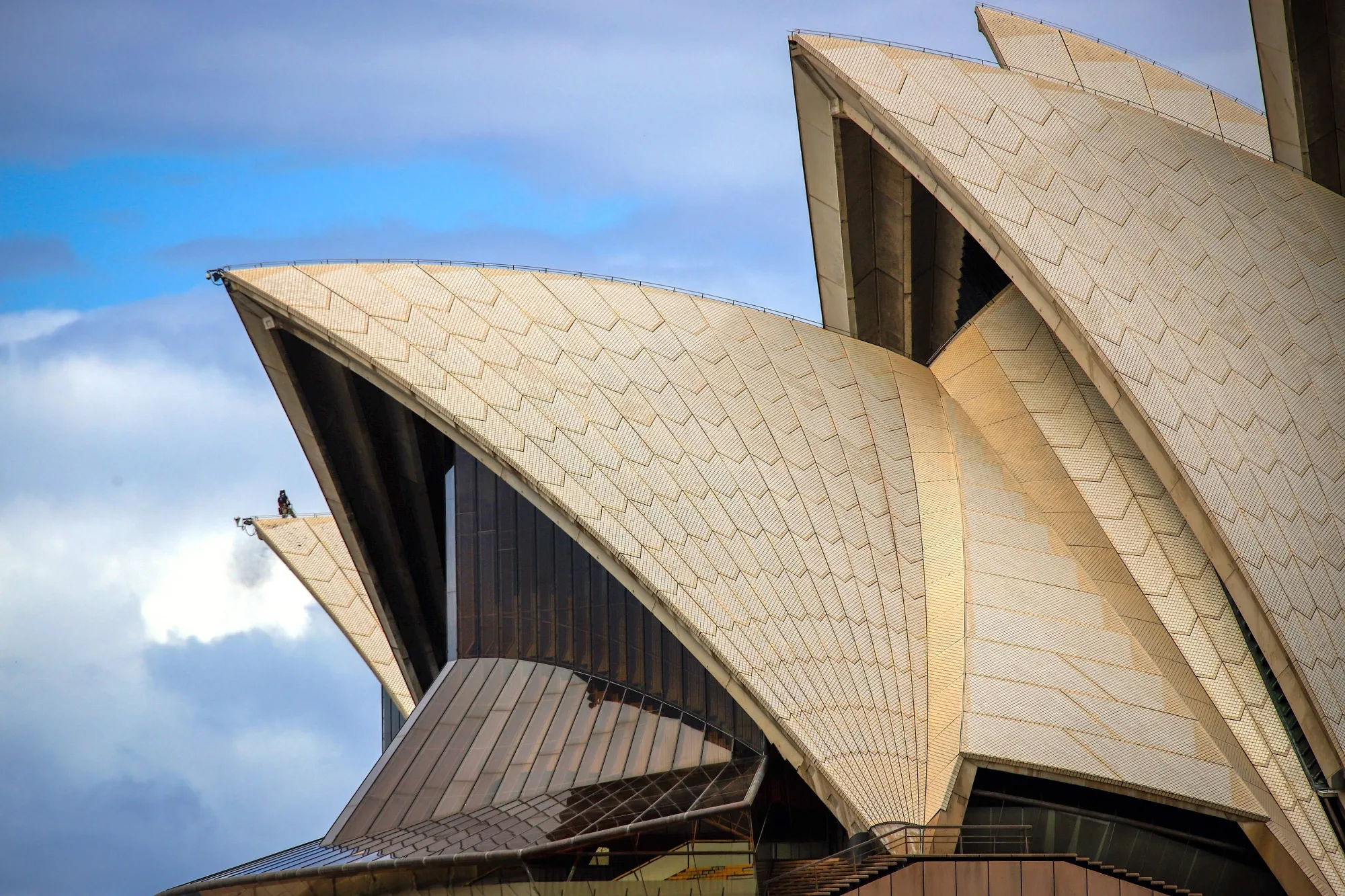 A worker atop the roof of the Sydney Opera House in 2020. After a lengthy refurbishment, the iconic building celebrates its 50th anniversary this year. 