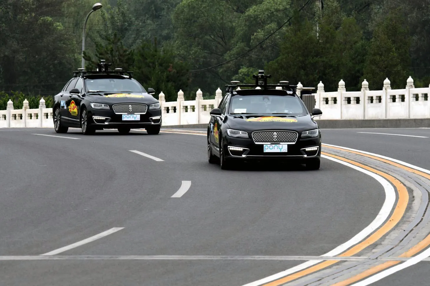 Pony.ai vehicles on the road during a Beijing permit test.