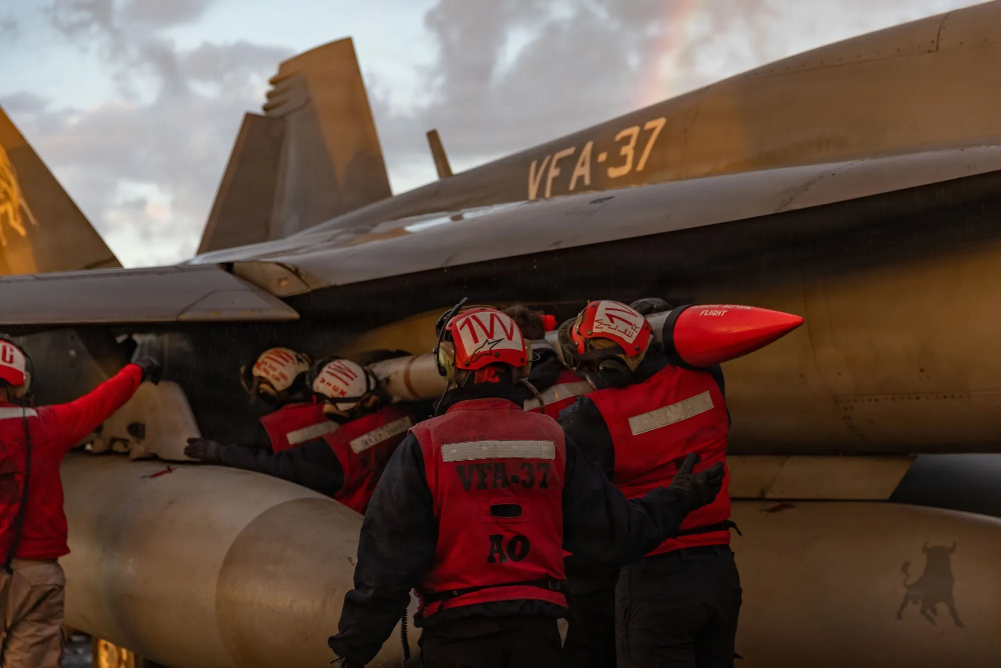 US sailors attach ordnance to an F/A-18E Super Hornet fighter jet aboard the USS Gerald R. Ford aircraft carrier, on Feb. 28.