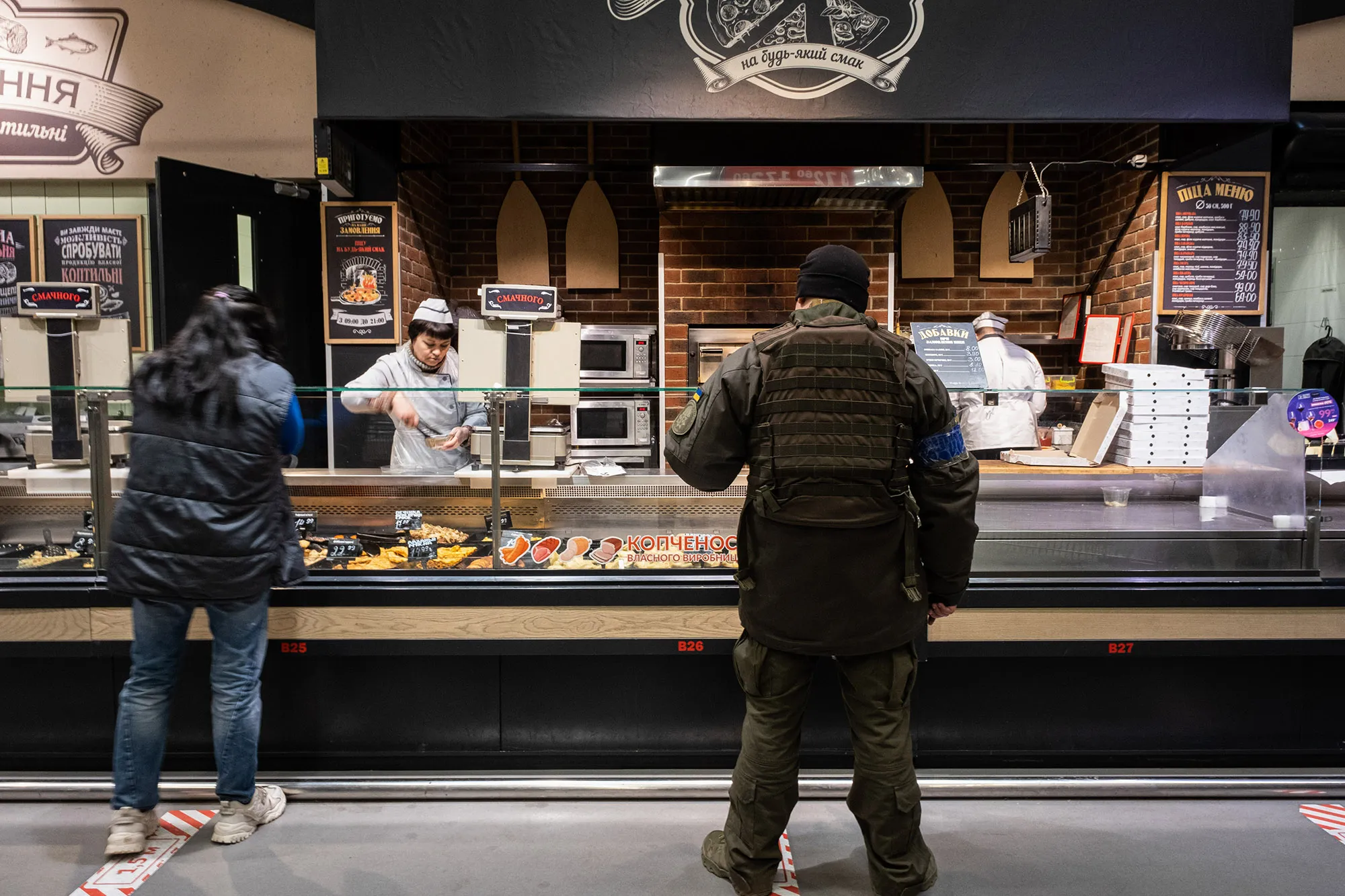 A Ukrainian soldier shops for food in a supermarket in Kyiv, on March 18.
