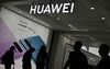 Visitors walk past the booth of Huawei promoting its P30 Pro smartphone at the international electronics and innovation fair IFA in Berlin on September 6, 2019. - Exhibitors from more than 100 countries will be presenting their latest products during the fair running from September 6 to 11, 2019. (Photo by Tobias SCHWARZ / AFP) (Photo credit should read TOBIAS SCHWARZ/AFP/Getty Images)