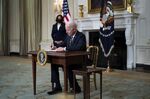 Joe Biden signs an executive order in the State Dining Room of the White House in Washington, D.C., on Feb. 24.