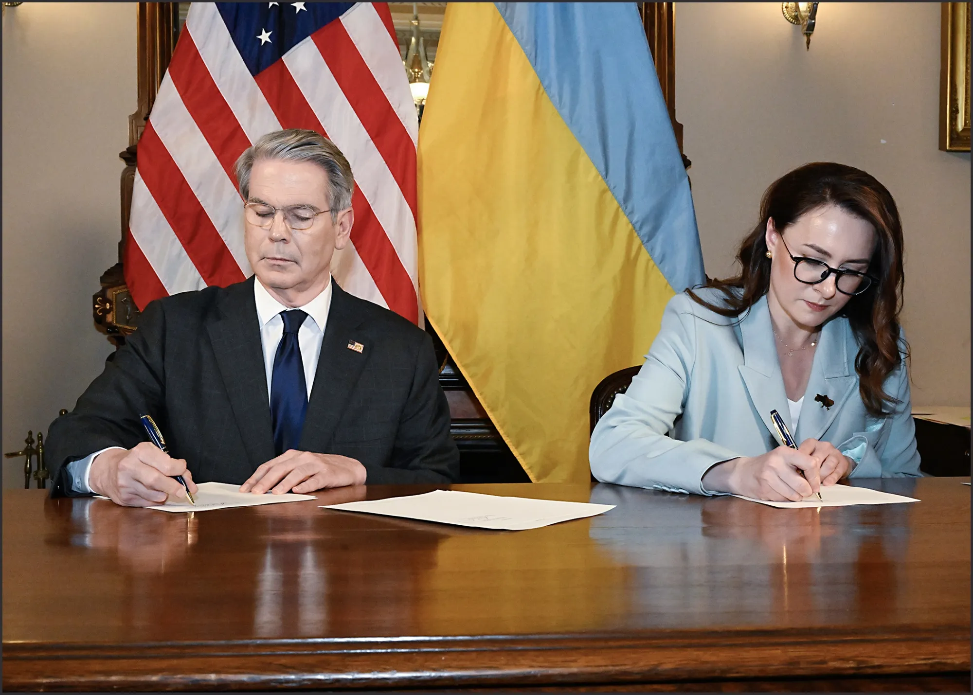 Scott Bessent and Yulia Svyrydenko during a signing ceremony.