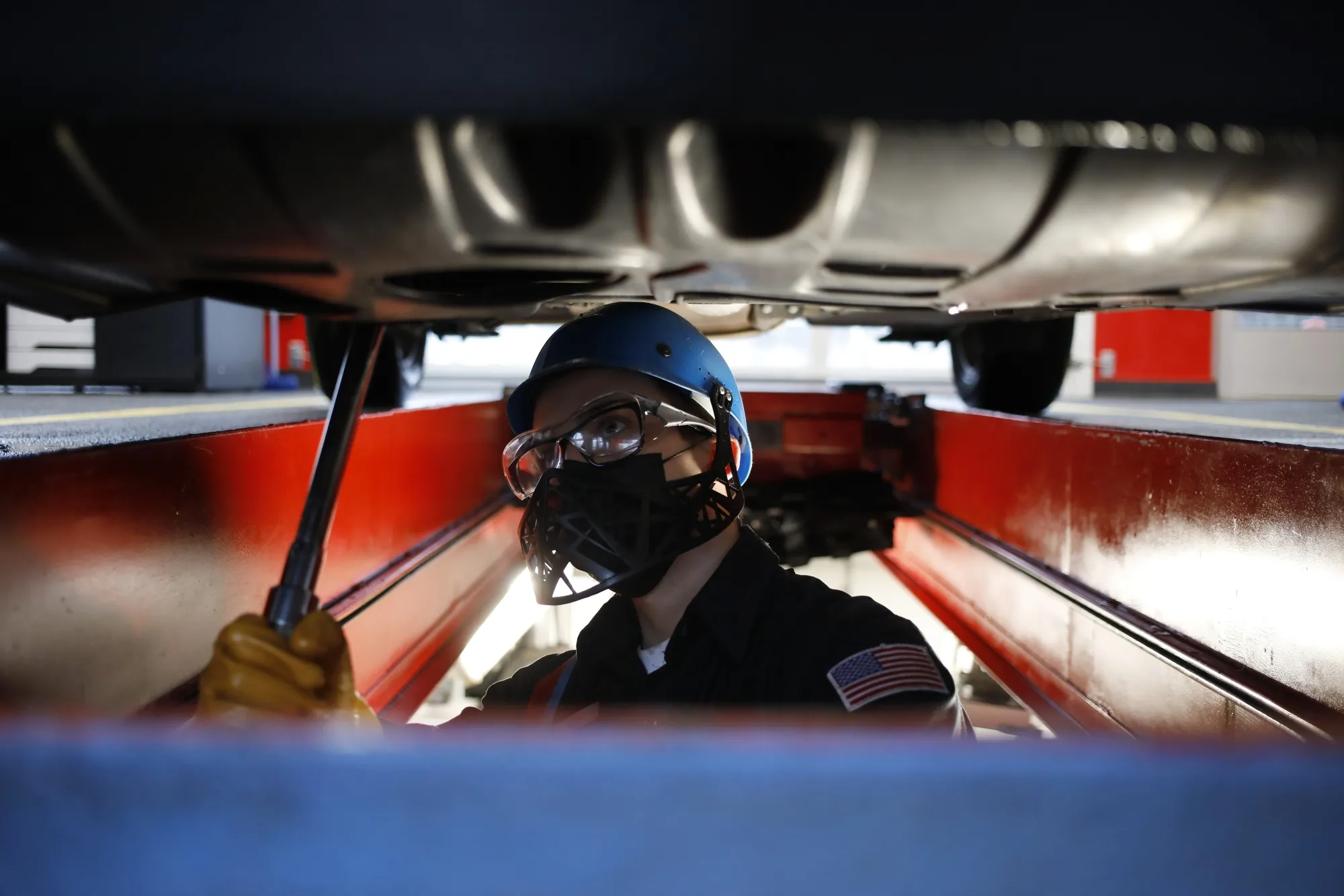 A worker underneath a vehicle at an oil change shop in Indianapolis, Indiana on&nbsp;Feb. 2.