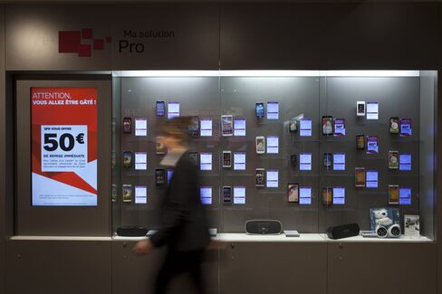 An Employee Passes Mobile Phones in an SFR Store in Paris