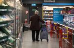 A shopper pulls a trolley along a chilled and frozen goods aisle, during a time set aside for elderly and vulnerable members of the community to shop, at an Iceland Foods Ltd. store in London, U.K.