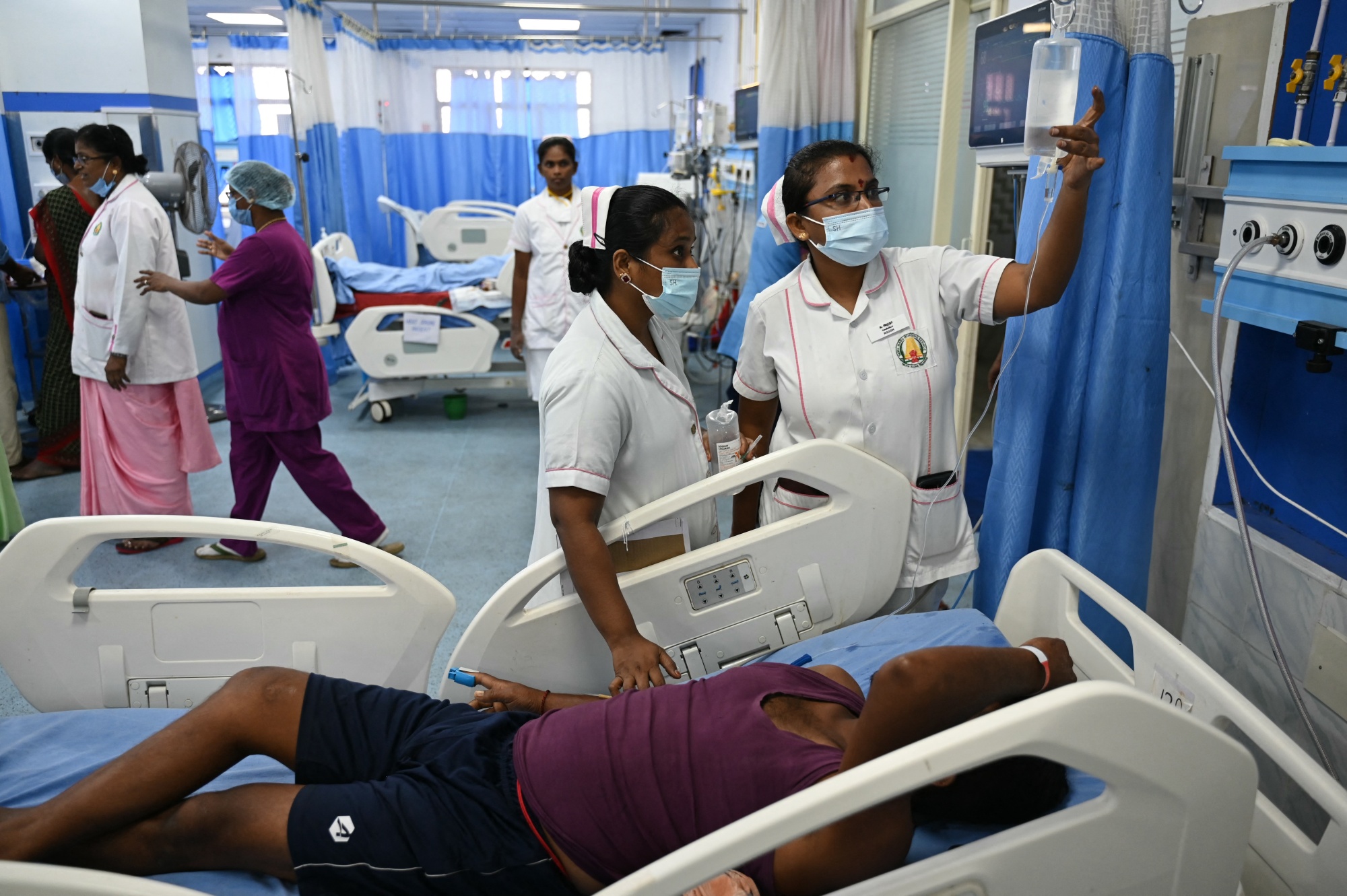 Nurses provide medical care to a patient at a special ward for heat stroke patients at a government hospital in Chennai on May 7, 2024. (Photo by R.Satish BABU / AFP) (Photo by R.SATISH BABU/AFP via Getty Images) Photographer: R.SATISH BABU/AFP