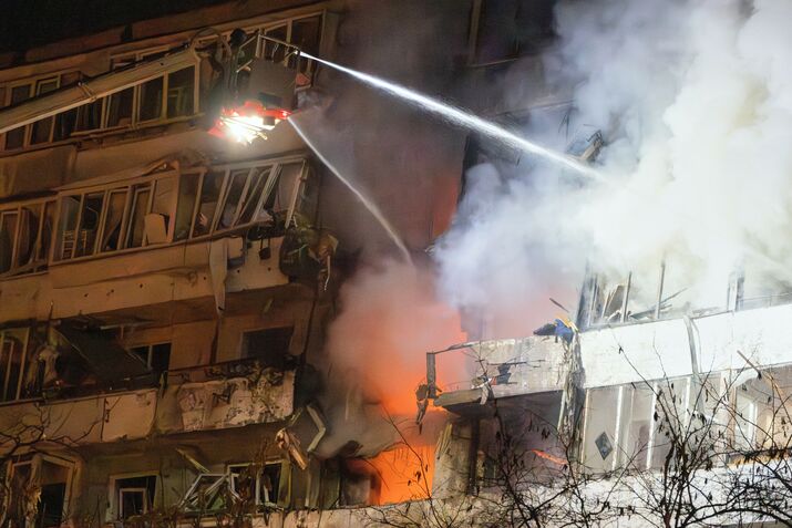 Emergency services attend the scene of a Russian attack in Kyiv, on Nov. 25.