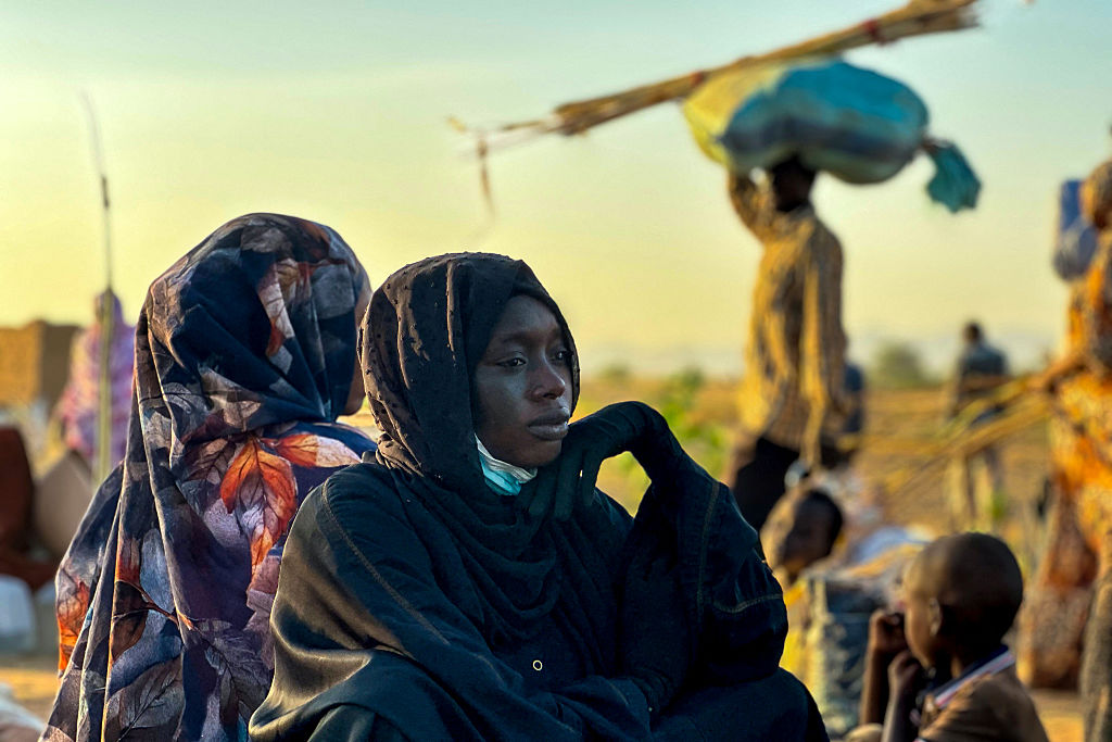 TOPSHOT - A displaced woman rests in Tawila, in the country's war-torn western Darfur region, on October 28, 2025, after fleeing El-Fasher following the city's fall to the Rapid Support Forces (RSF). Fears mounted in Sudan on October 28, three days after paramilitaries seized the key city of El-Fasher, amid reports of mass atrocities and the killing of five Red Crescent volunteers in Kordofan. The capture of El-Fasher, the historic heart of Darfur, has sparked fears of mass killings reminiscent of the region's darkest days. (Photo by AFP) (Photo by -/AFP via Getty Images) Photographer: -/AFP
