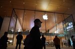 People walk past an Apple store in Beijing on October 19, 2020. (Photo by GREG BAKER / AFP) (Photo by GREG BAKER/AFP via Getty Images)