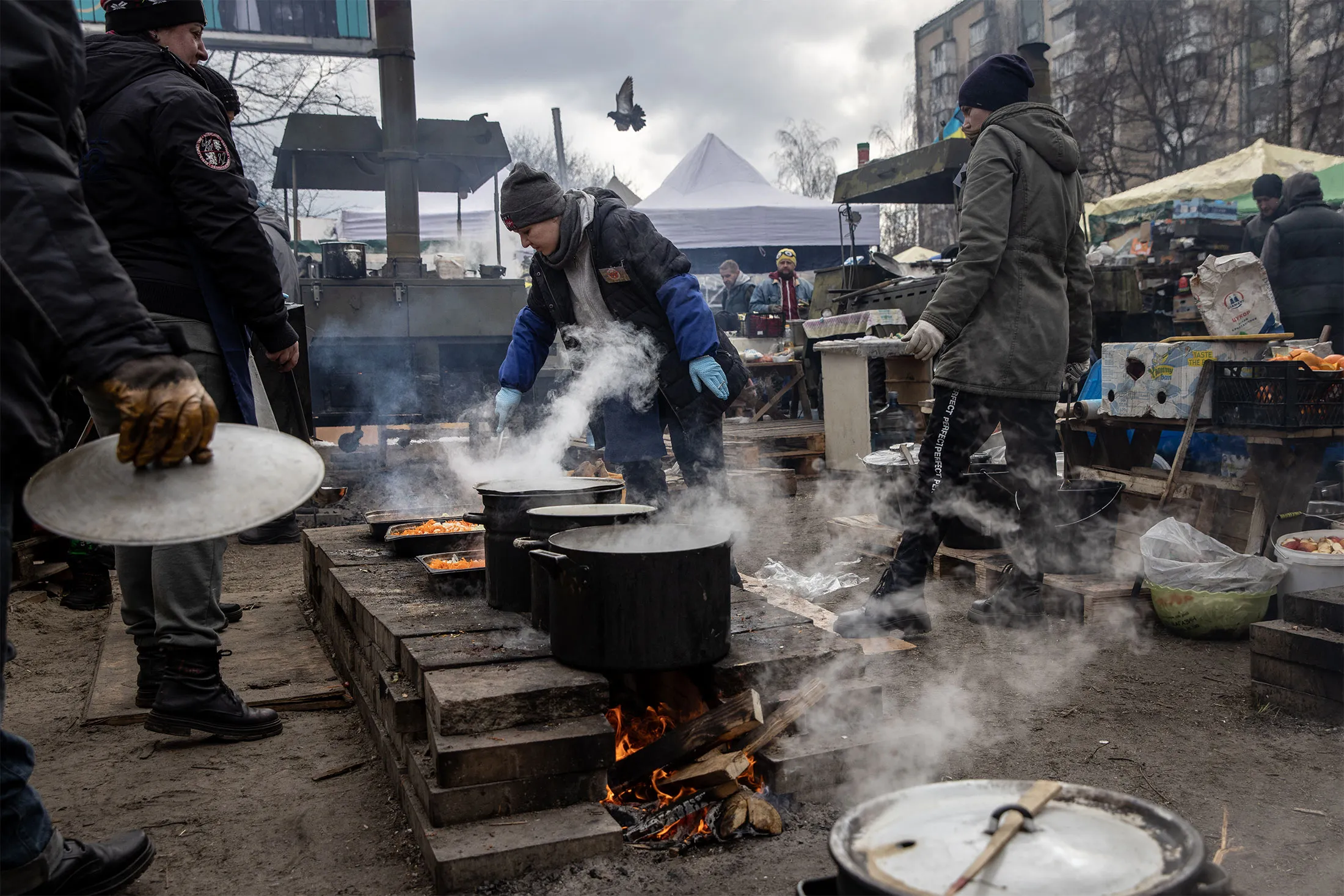 Volunteers make food to feed soldiers and civilians at a roadside camp close to the north eastern frontline in Kyiv on March 9.