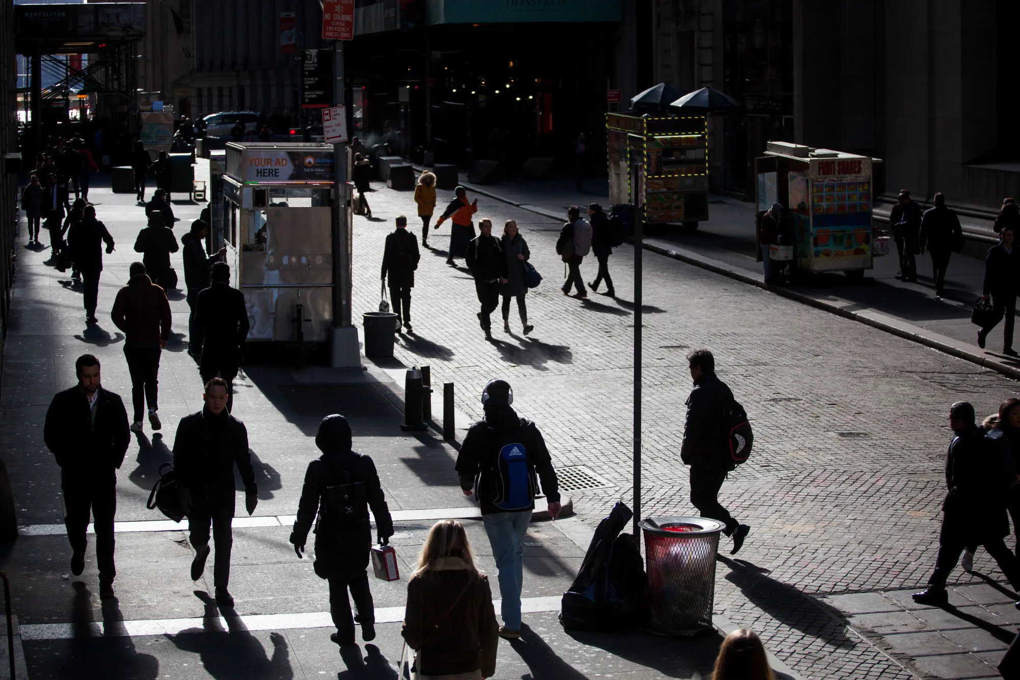 Pedestrians walk along Wall Street in New York.