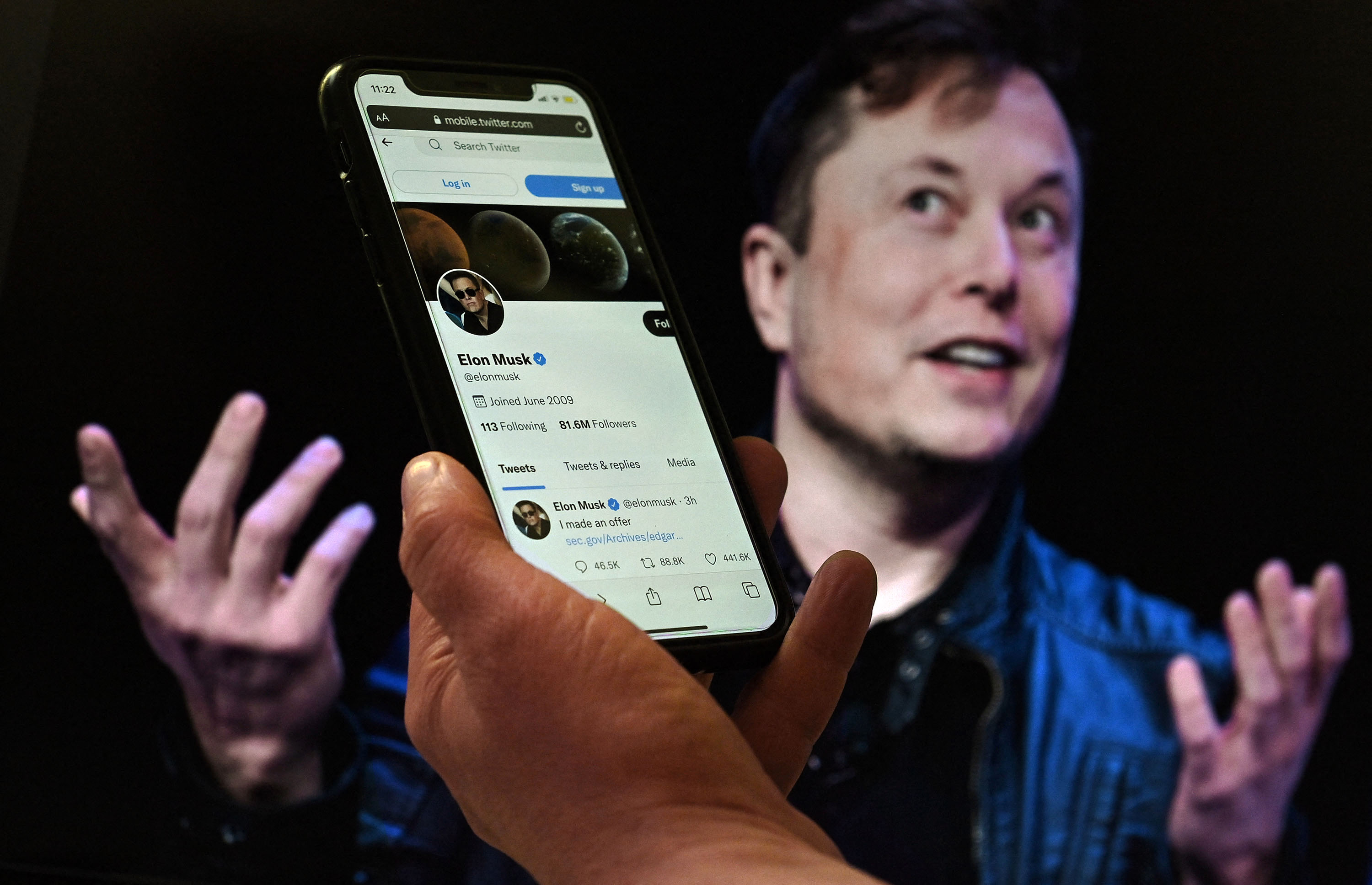 Photo illustration of Elon Musk and Twitter on an iPhone.