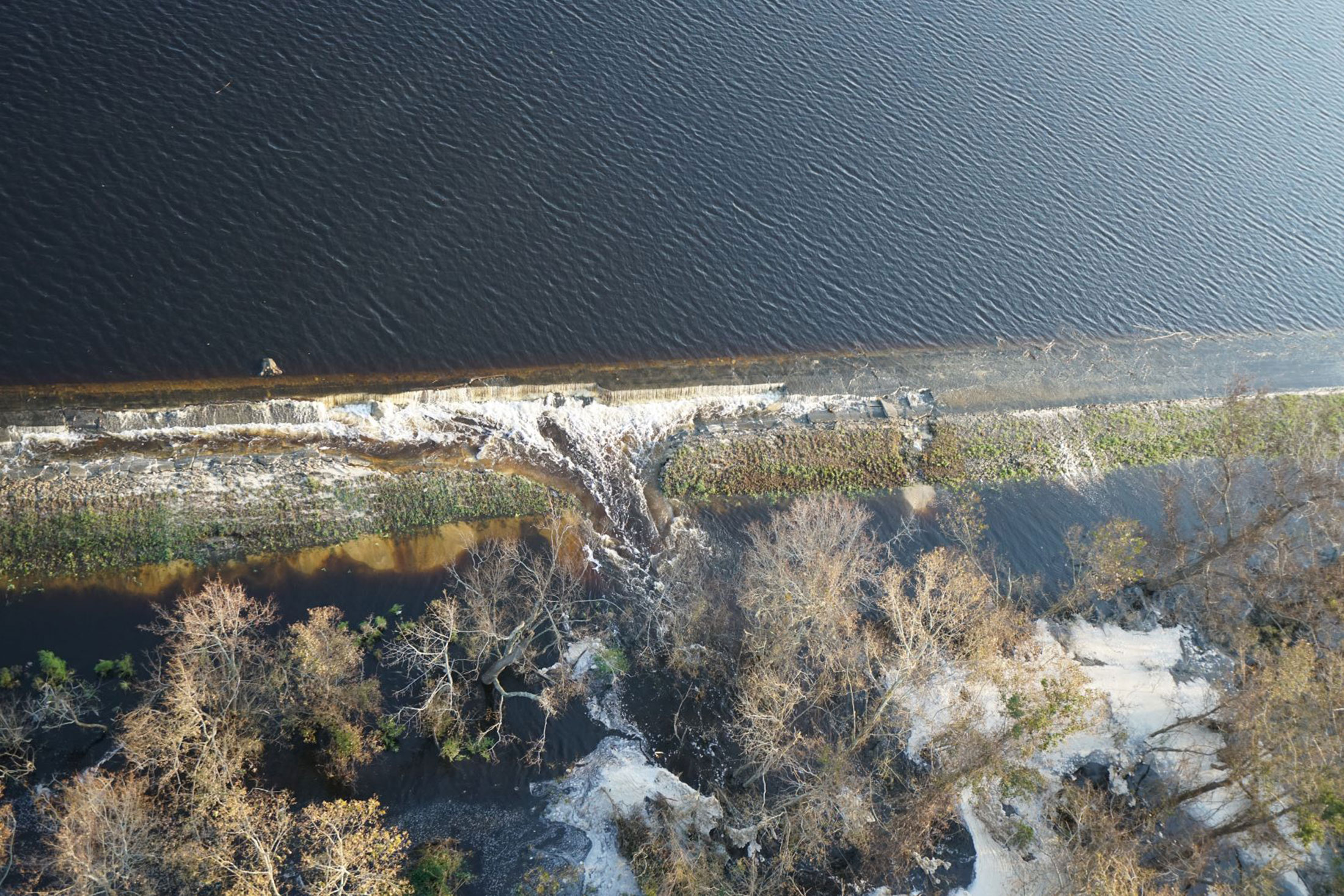 Coal byproduct is seen&nbsp;spilling over&nbsp;Sutton cooling lake into the Cape Fear River.&nbsp;