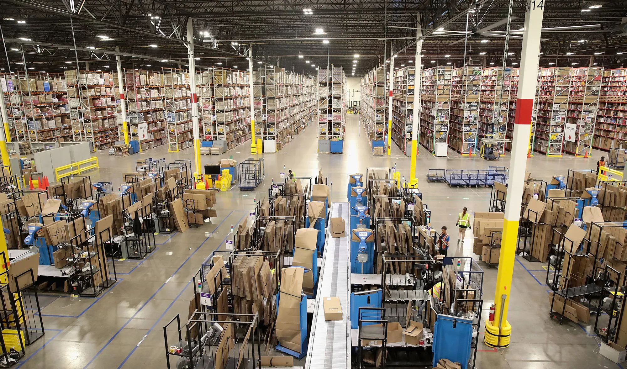 Workers pack and ship customer orders at the 750,000-square-foot Amazon fulfillment center on August 1, 2017 in Romeoville, Illinois.