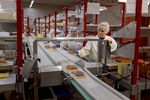 BONITA, ARIZONA APRIL 23: Workers place packaged boxes of cherry tomatoes onto a conveyor to be placed into boxes for shipping out at the NatureSweet production facility in Bonita, Arizona on April 23, 2025. (Anna Watts For The Washington Post via Getty Images)