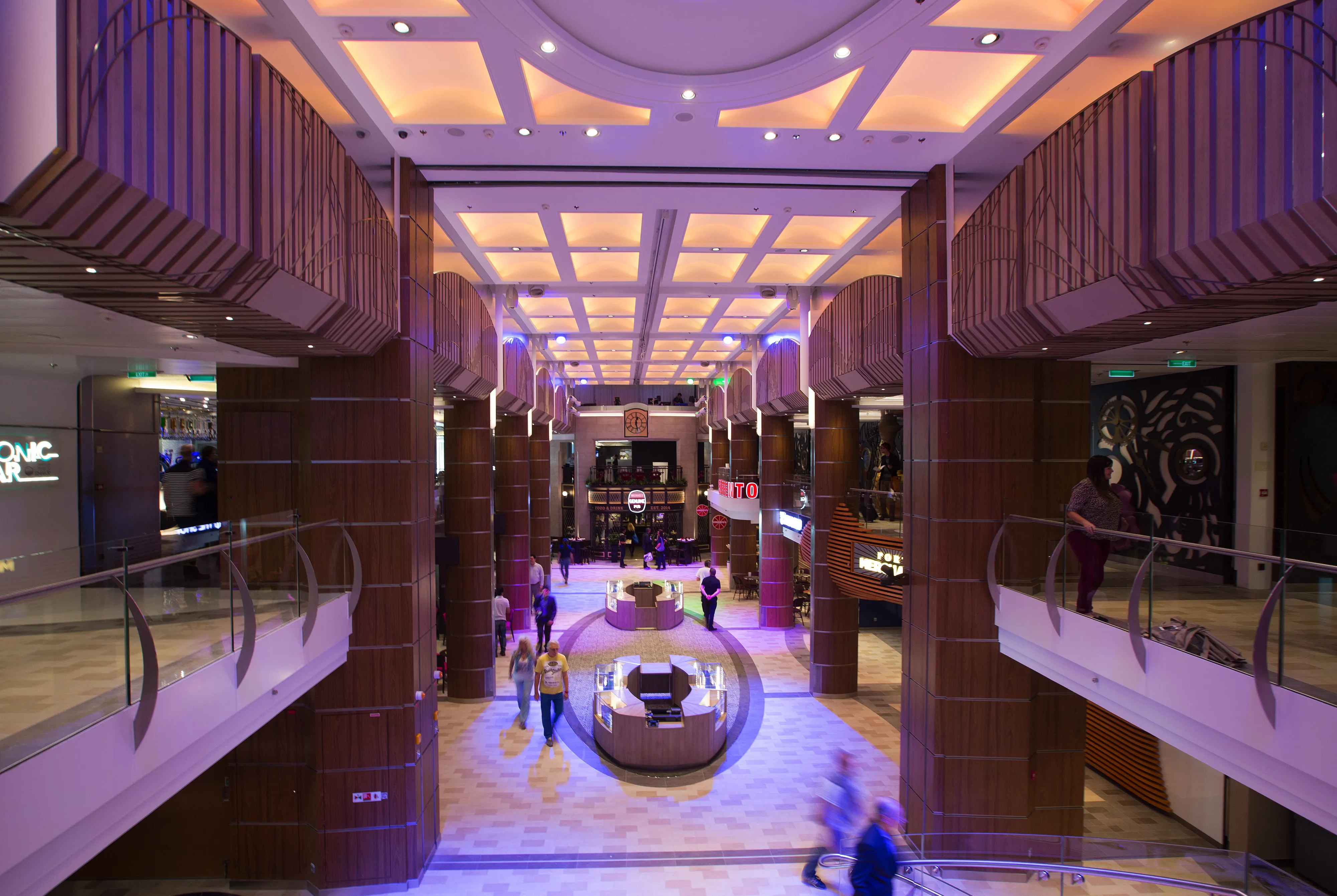 Guests walk through the Royal Esplanade on Royal Caribbean's Quantum of the Seas cruise ship.
