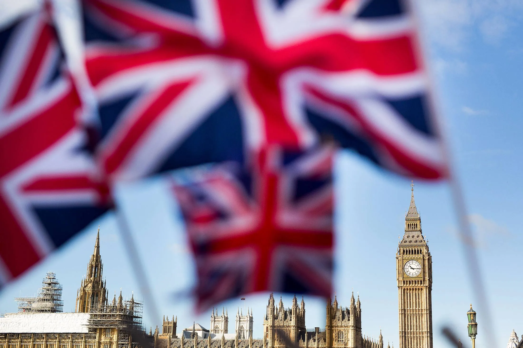 A display of U.K., Union Jack flags fly in front of The Houses of Parliament, in London, U.K., on Monday, Feb. 15, 2016. U.K. lawmakers are not the only ones bracing for a tough few months before Britain's referendum on its European Union membership. A gauge of expected volatility for the pound near the highest since 2011 shows traders are expecting a rough ride too.
