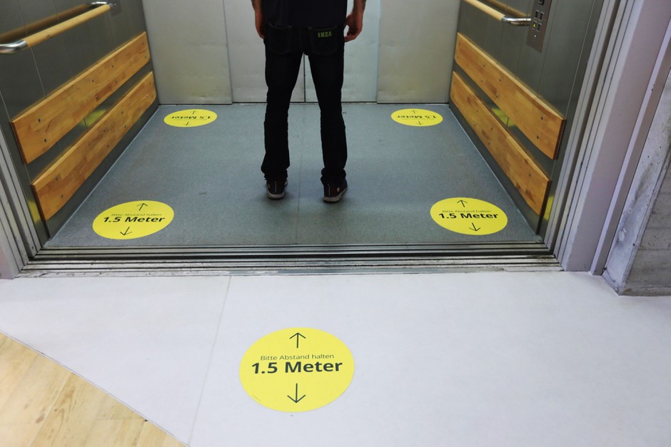 Going up? Social-distancing stickers help elevator passengers at an IKEA store in Berlin.