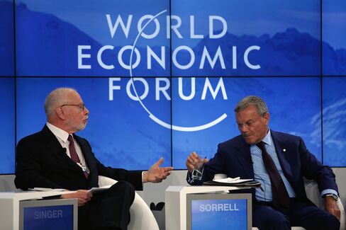 Paul Singer, left, and Martin Sorrell, speak at Davos.