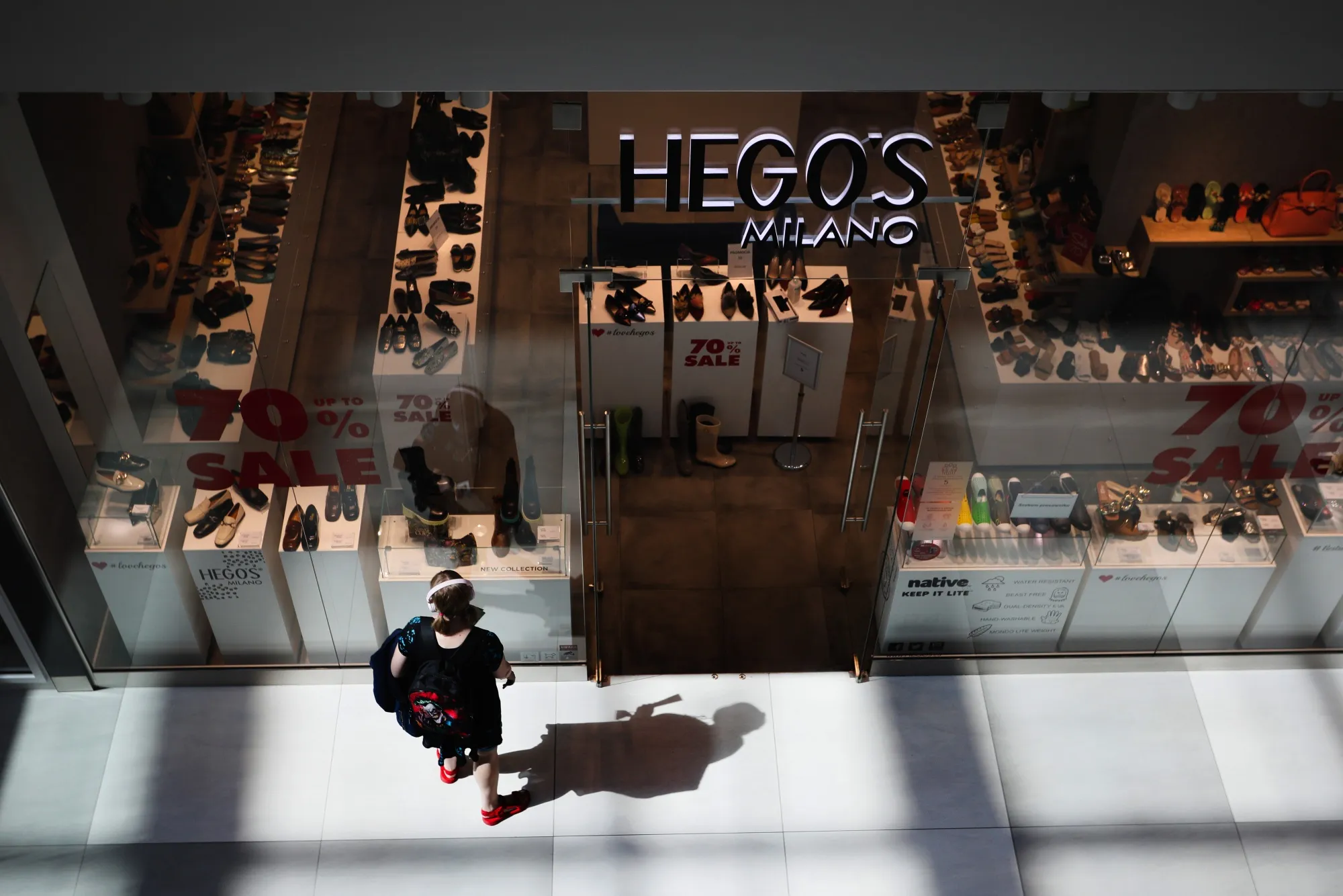 A shopper browses footwear inside the Galeria Mlociny shopping mall in Warsaw, Poland.