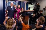 Vice President Mike Pence, left, joins White House press secretary Sarah Sanders, during a briefing at the White House on April 25, with children of White House staff and journalists.