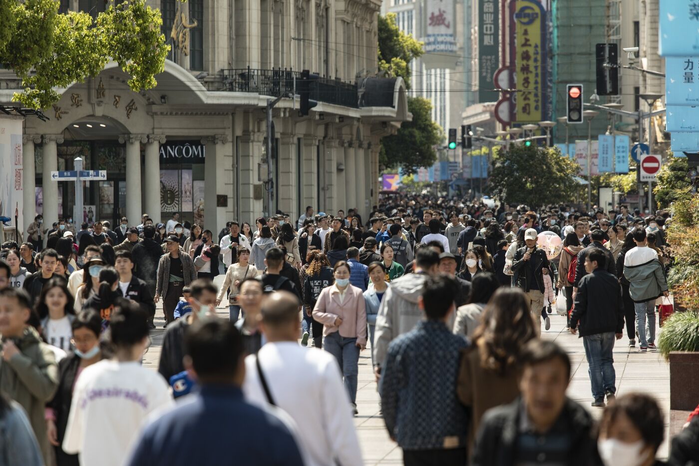 Shoppers walk down Nanjing East Road, one of the city's main commercial and tourist area, in Shanghai, China.