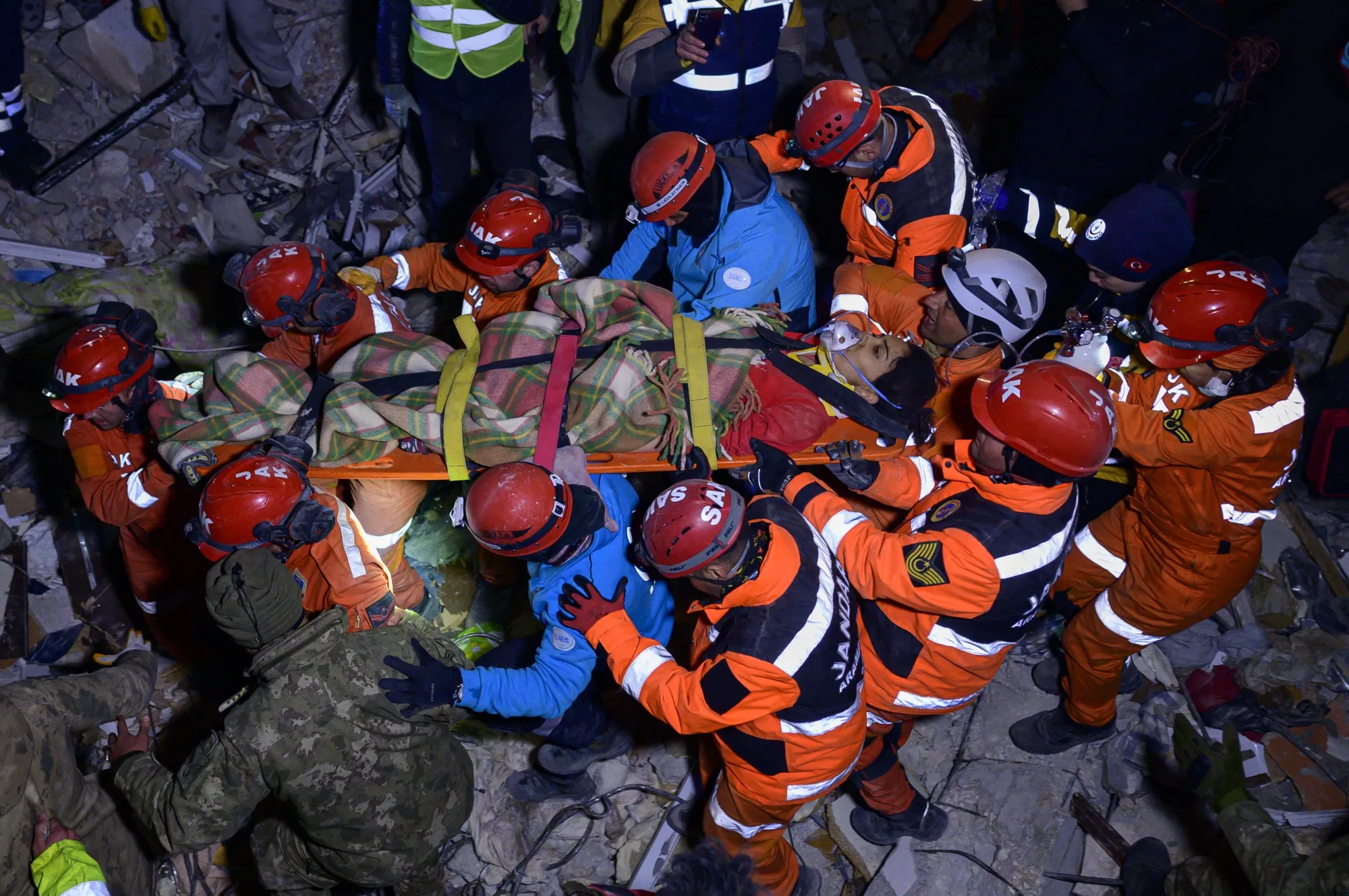 Rescuers carry a person on a stretcher after&nbsp;removing&nbsp;from under the rubble of a collapsed building in Hatay province, southern Turkey on Feb. 10.