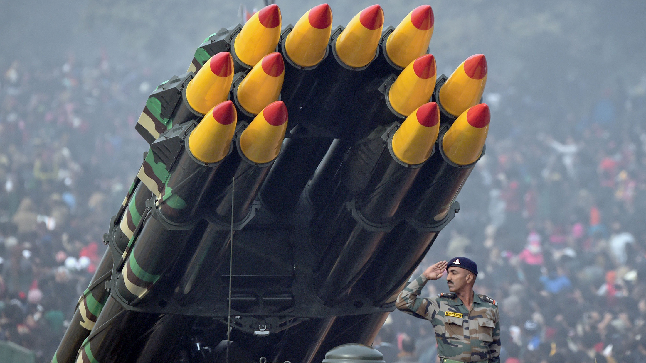 TOPSHOT - An Indian soldier salutes as he rides a Smerch rocket launcher during India's Republic Day parade in New Delhi on January 26, 2016. Thousands gathered in New Delhi amid tight security January 26 for India's annual Republic Day parade, a pomp-filled spectacle of military might featuring camels and daredevil stuntwomen, with French President Francois Hollande the chief guest. / AFP / ROBERTO SCHMIDT (Photo credit should read ROBERTO SCHMIDT/AFP/Getty Images)
