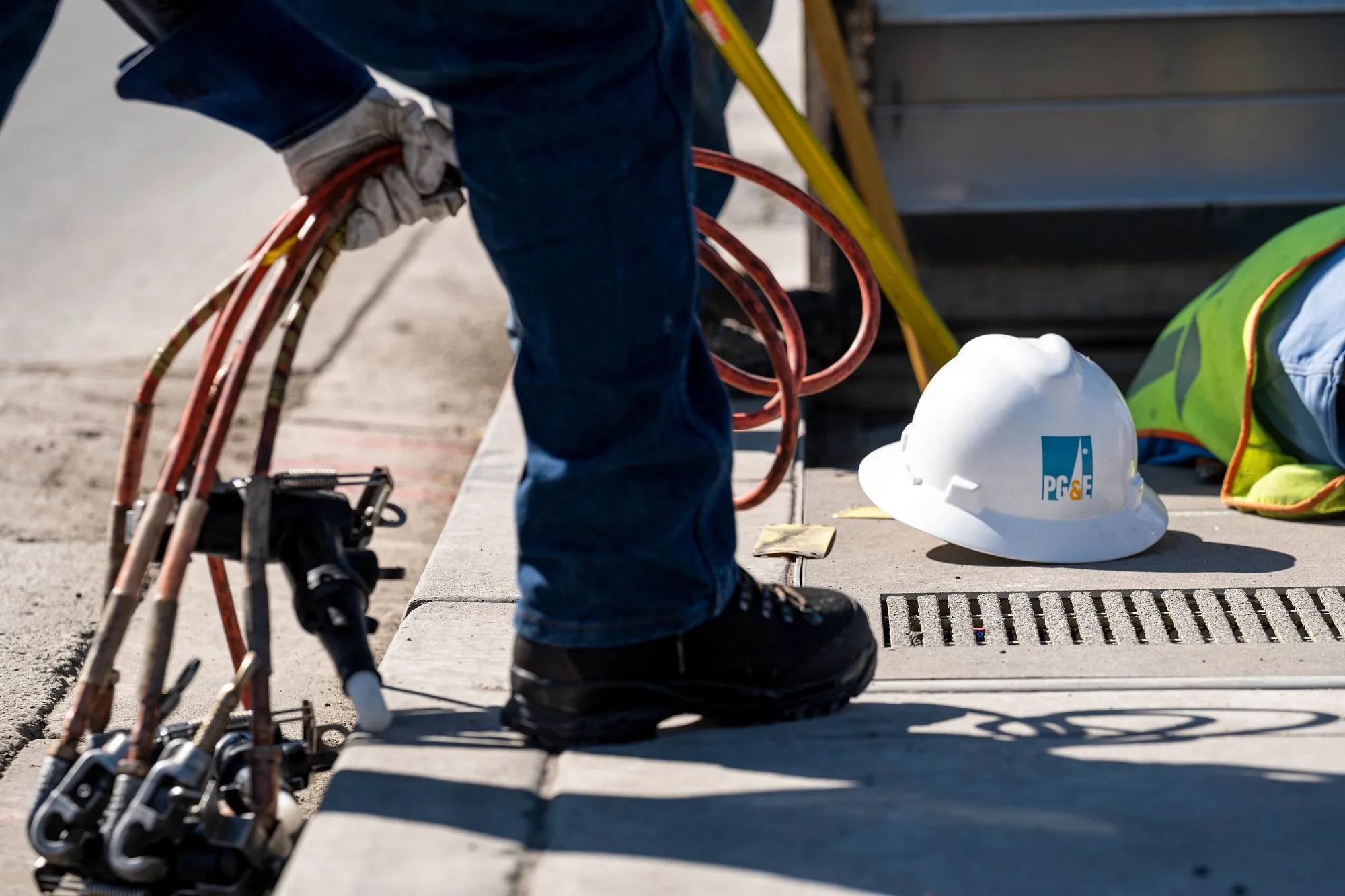 A PG&amp;E&nbsp;worker holds cables on a job site in San Francisco.