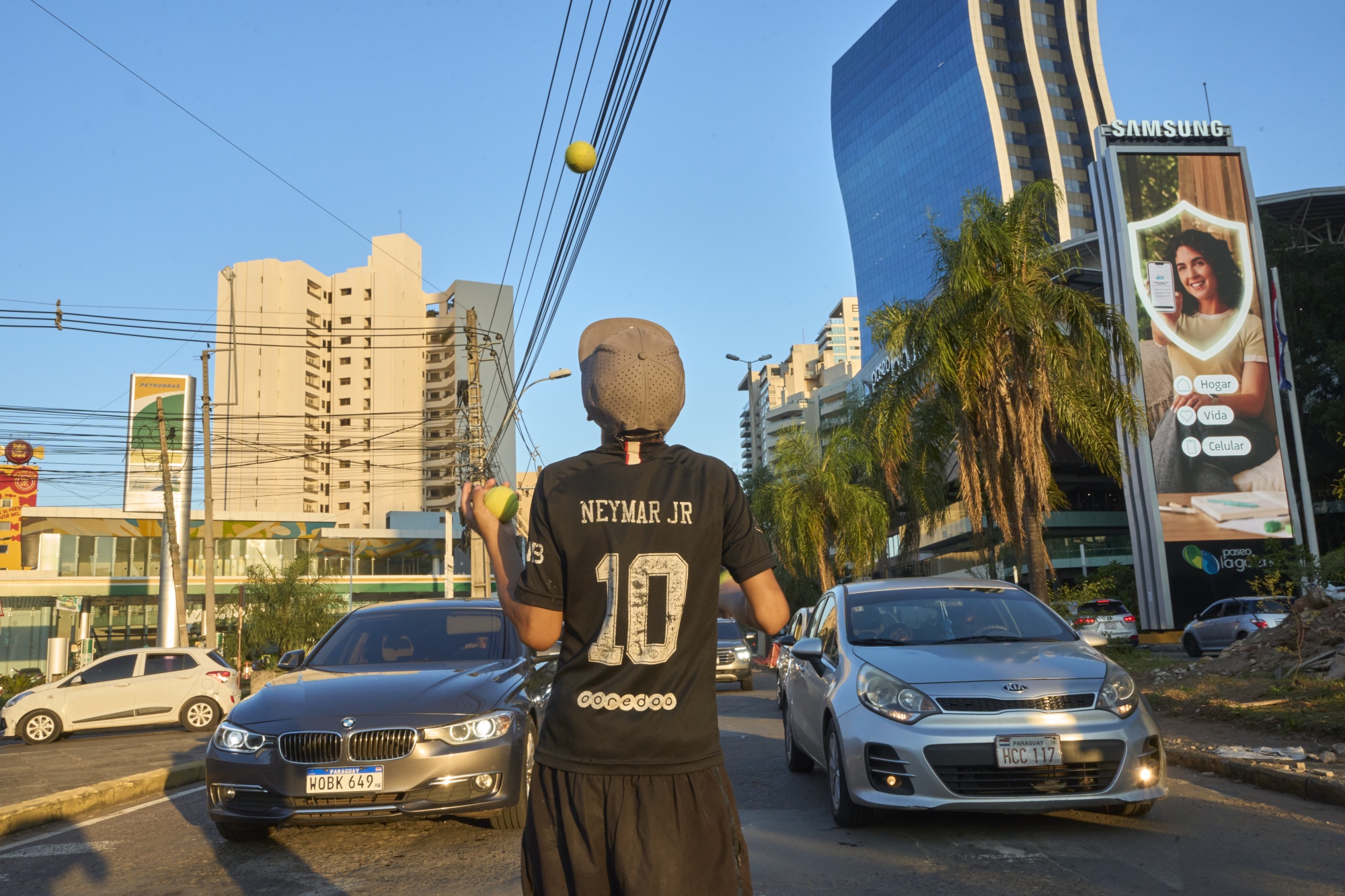 A boy juggles in front of cars at a traffic light in Asunción, Paraguay's new corporate hub on Wednesday, February 25, 2026. Credit: Santi Carneri / Bloomberg Photographer: Santi Carneri/Bloomberg