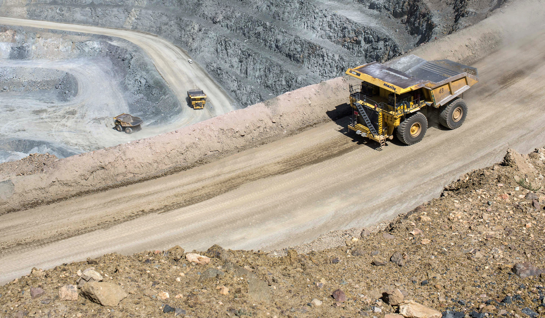 Dump trucks operate in an open pit at the Oyu Tolgoi copper-gold mine, jointly owned by Rio Tinto Group's Turquoise Hill Resources Ltd. unit and state-owned Erdenes Oyu Tolgoi LLC, in Khanbogd, the South Gobi desert, Mongolia, on Saturday, July 23, 2016. Mongolia exported 817,000 tons of copper concentrate in the first half of the year compared with 663,800 tons a year earlier, an increase of 23.1 percent.

