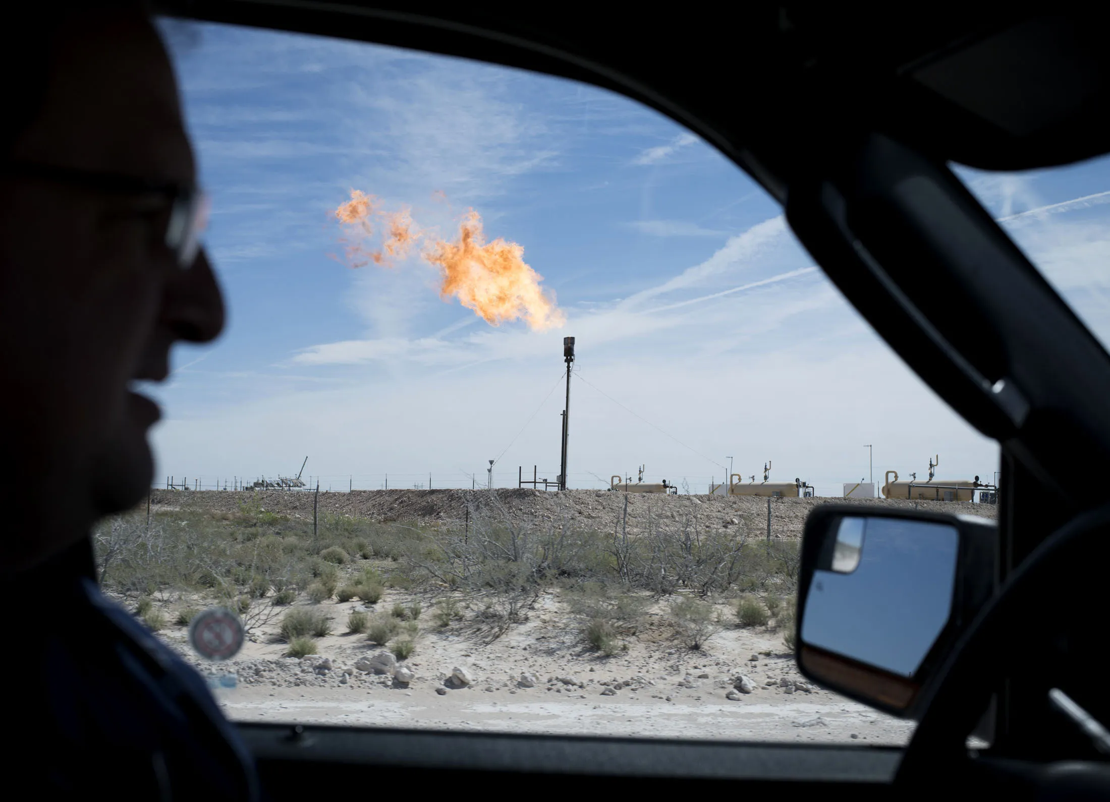A gas flare is seen through the window as Royal Dutch Shell's Scott W. Scheffler drives near Mentone, Texas in Loving County located in a central portion of the Delaware Basin on Thursday, March 2, 2017.

