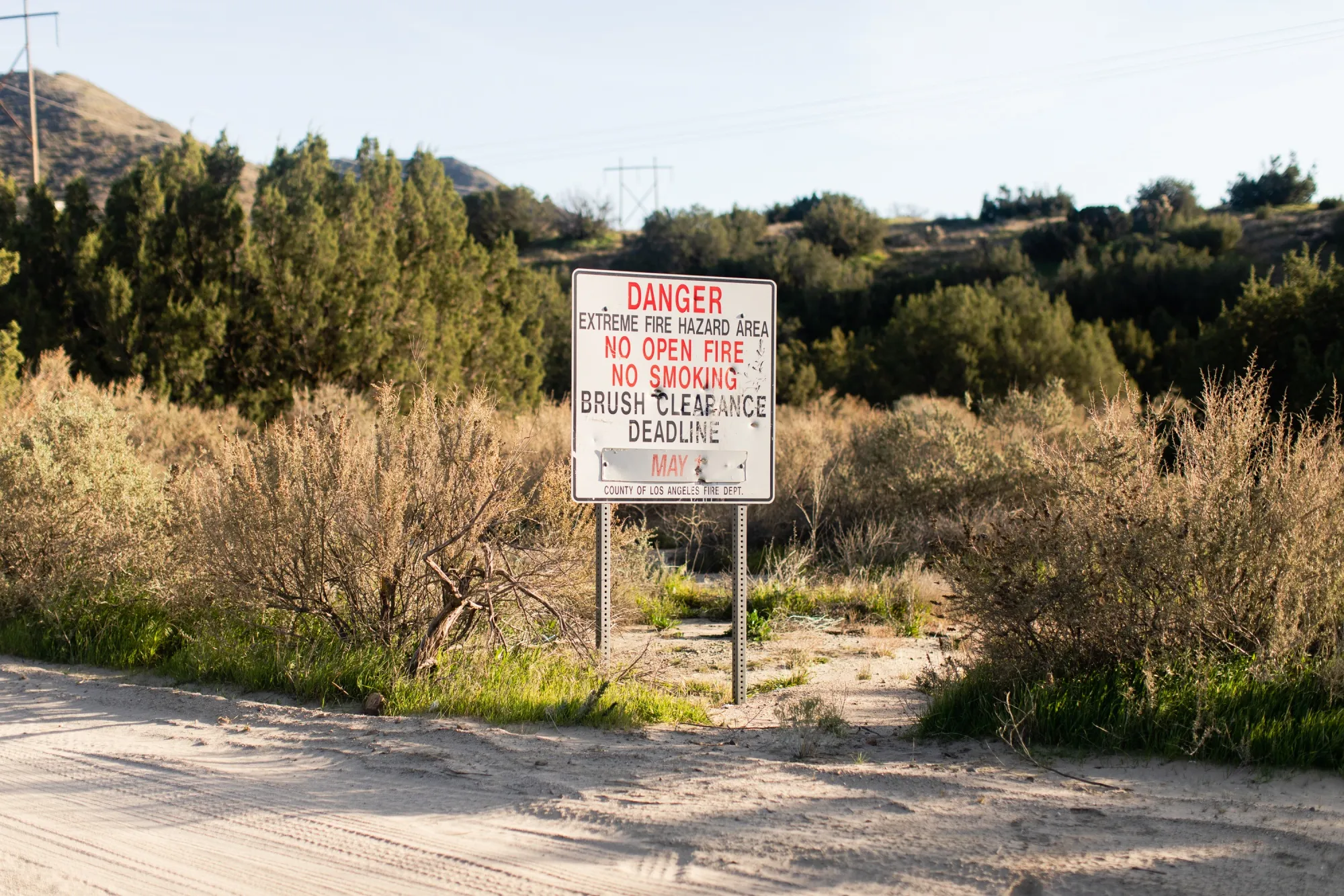 A sign warning of fire danger in Acton, California, near the site of a proposed battery installation.