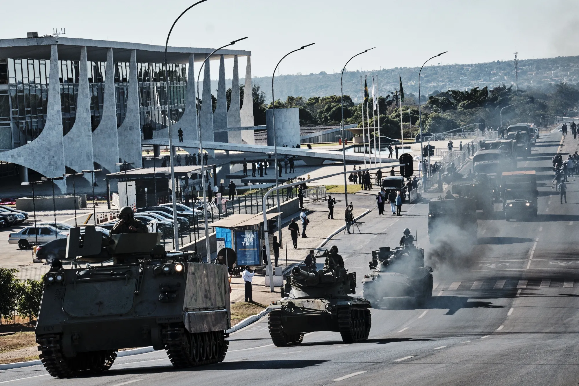 Armored vehicles and tanks drive past the presidential palace during a military parade in Brasilia on Aug. 10, 2021.