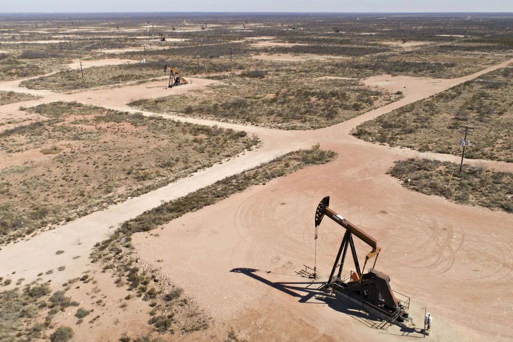 Pumpjacks operate on oil wells in the Permian Basin in this aerial photograph taken over Crane, Texas.