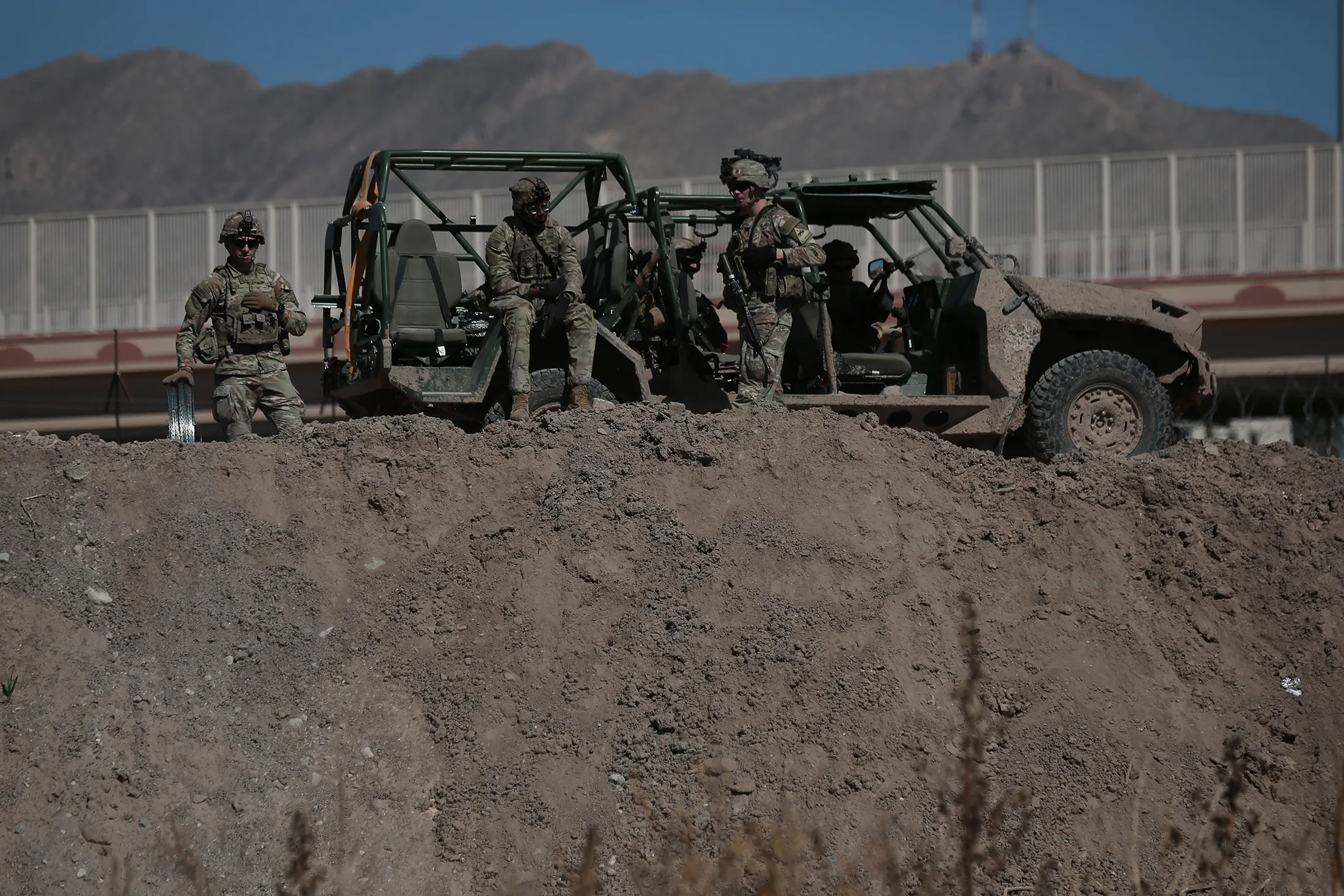 US military members monitor and install barbed wire fences along the Rio Grande River following the suspension of flights in El Paso, Texas, on Feb. 11.
