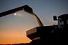 Soybeans are unloaded from a Case IH Agricultural Equipment Inc. combine harvester at dusk during harvest in Buda, Illinois, U.S., on Friday, Sept. 29, 2017.