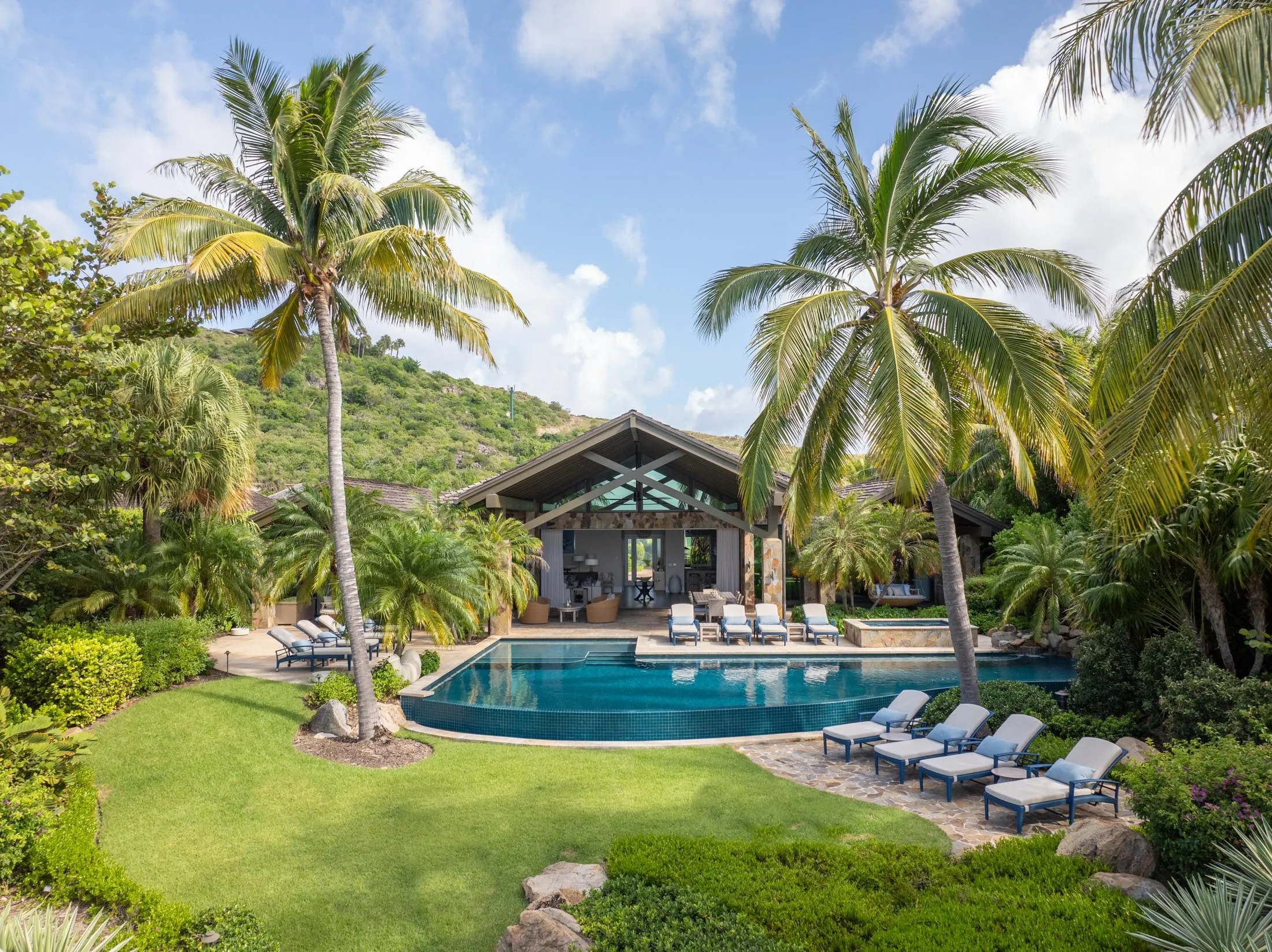 A large, covered entertaining area overlooks the pool and lawn.