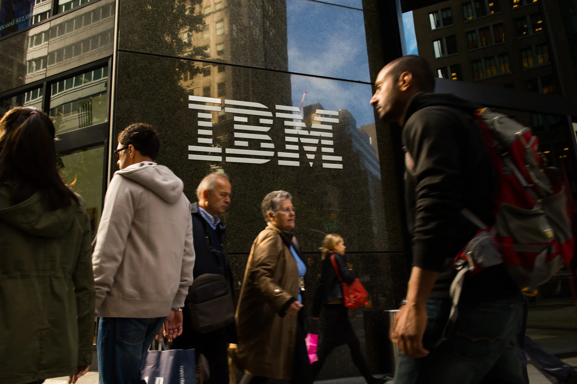 Pedestrians walk past IBM's offices in New York.