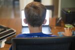 A high school student works on an assignment on a laptop computer at home during a remote learning day in Princeton, Illinois, U.S., on Wednesday, Aug. 19, 2020.