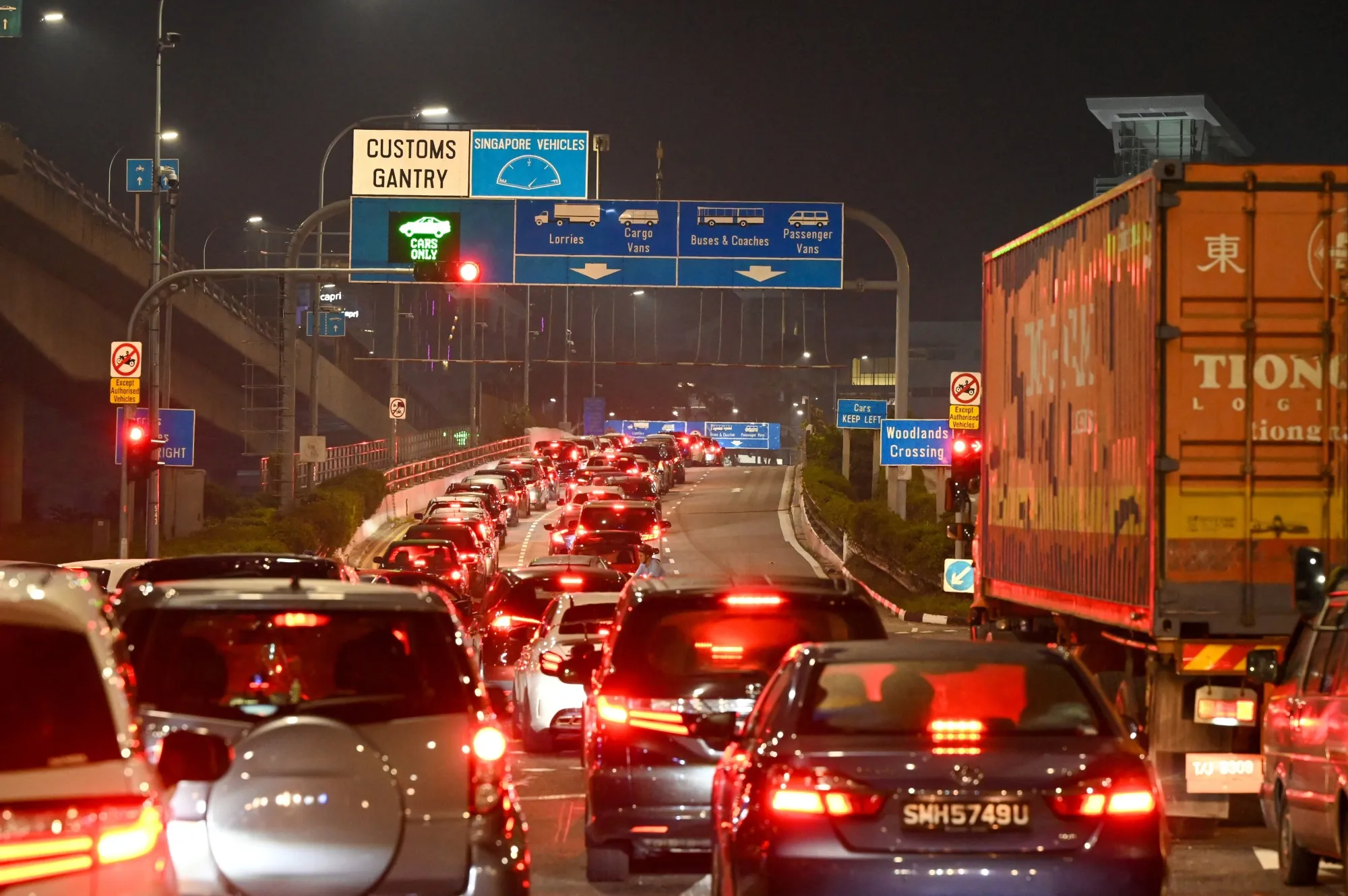 Vehicles queue to enter the Woodlands Checkpoint in Singapore early on April 1, before crossing the causeway to Malaysia’s southern Johor state.